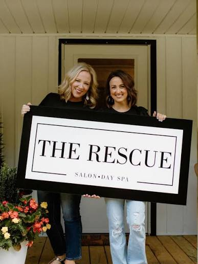 The Rescue Salon team holding The Rescue Salon sign